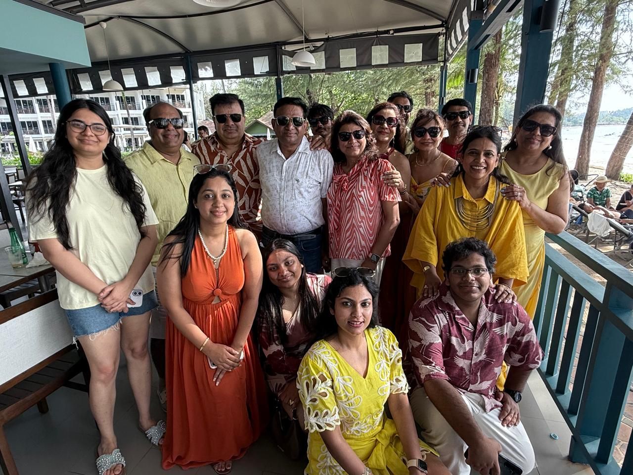 The whole group in yellow and orange at the beach restaurant
