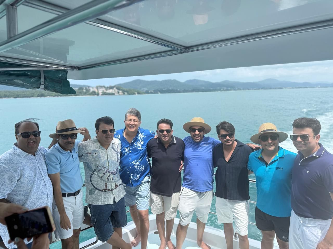 The men in blue on the catamaran deck