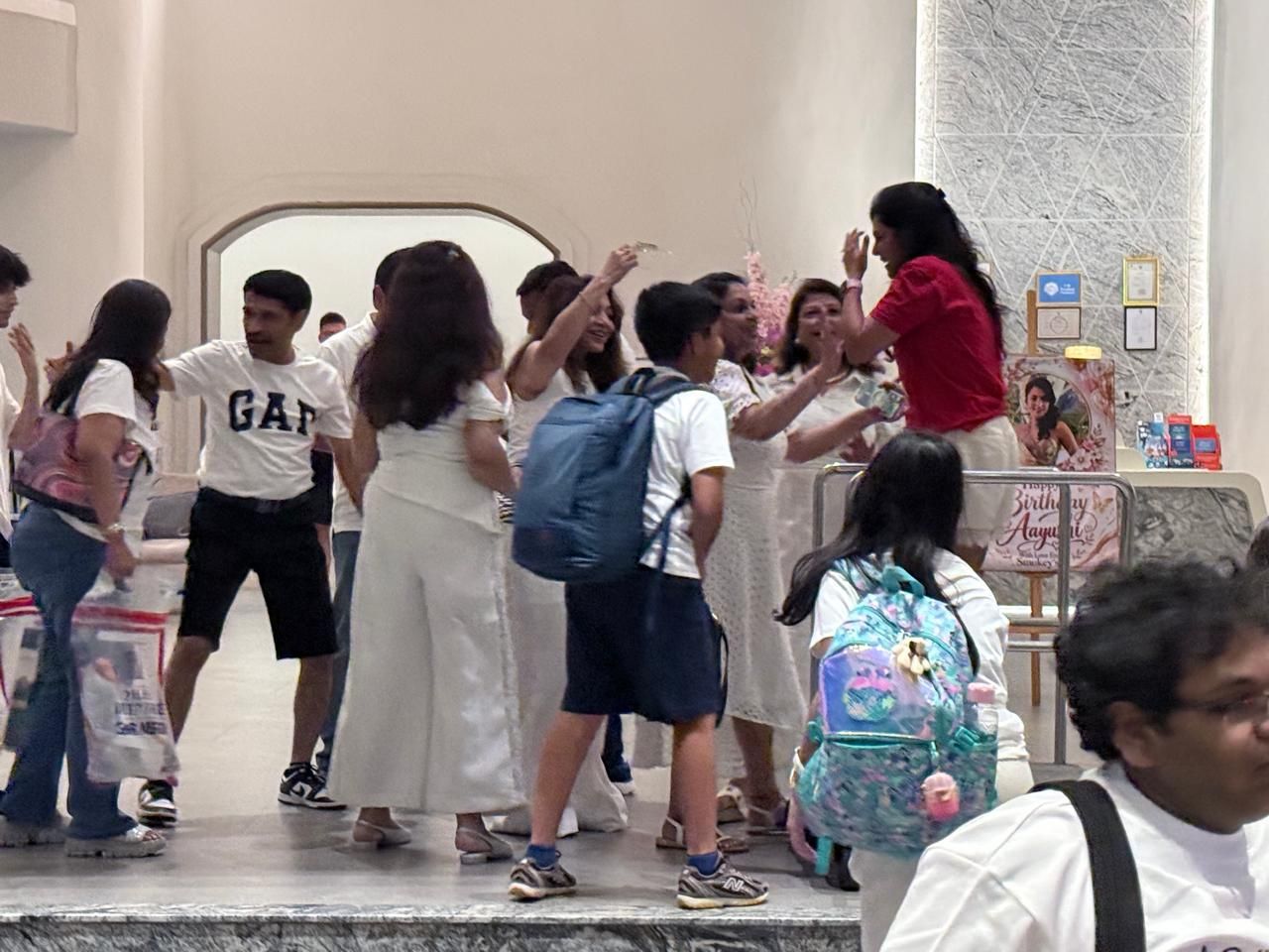 Guests in white arriving at the hotel lobby